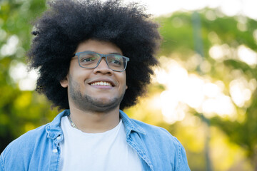 Portrait of young latin man outdoors.