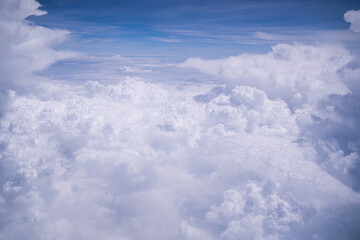 Atmosphere beautiful blue sky with clouds form plane. Flying above the clouds. Clouds blue sky High angle air. Background Clouds. A view from airplane window. View along the way.
