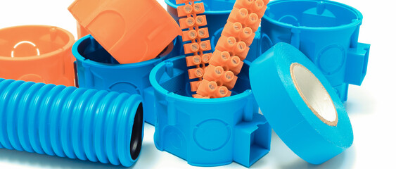 Orange and blue electrical boxes and other components using in electrical installations