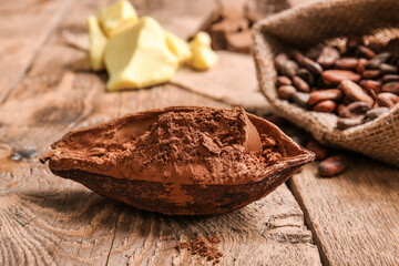 Beans and cocoa powder on wooden  background