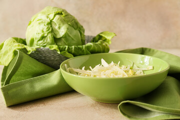 Plate with fresh cut cabbage on color background