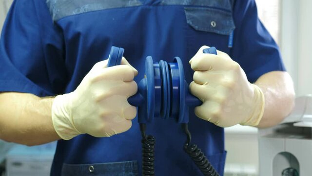 Defibrillation concept. Defibrolator in hands from eyes of patient. POV. Blue medical clothes. First aid. Doctor using defibrillation electrodes to save lives. resuscitator at work. Body resuscitation