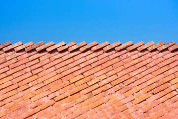 Red brick wall as stairs and the blue sky