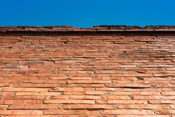Red brick wall and the blue sky, one third sky and two thirds wall