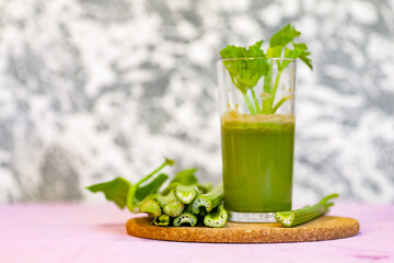 Healthy Celery diet for the treatment of incurable mysterious diseases. Fresh celery juice squeezed out on a juicer.drink, vegetable juice, studio shot