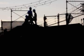Men working on roof at construction site