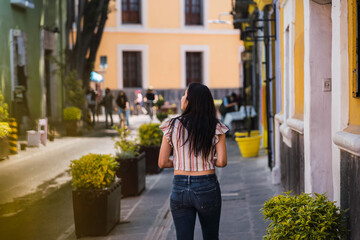 unrecognizable tourist walking on the street