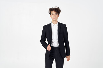 handsome guy with curly hair and in a jacket shirt pants model