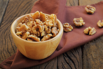 Walnut in a bowl put on fabric.