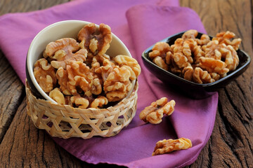 Walnut in a bowl put on fabric.