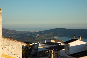 Some houses in a small town and a lake and the sea with blue skies