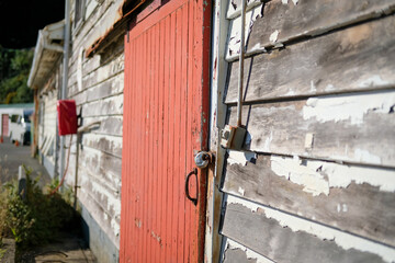 Delapidated building with red door needs some repair