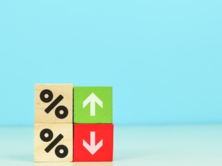 Wooden cubes with icon arrow up, down direction and percentage symbol. Interest,financial and mortgage rates concept.