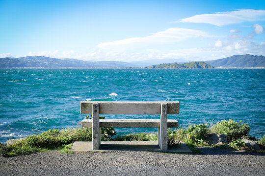 Seascope with solitary wooden bench at ocean edge