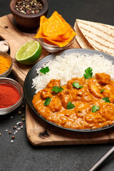 Plate of Traditional Chicken Curry and rice on dark concrete background