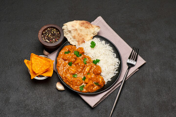 Plate of Traditional Chicken Curry and rice on dark concrete background