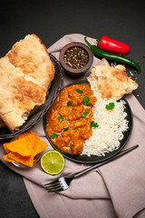 Plate of Traditional Chicken Curry and rice on dark concrete background