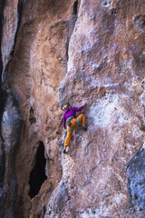 Fototapeta premium A girl trains strength and endurance on rocks