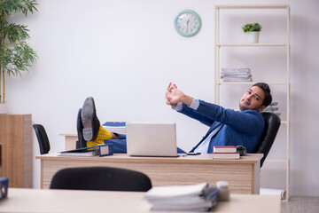 Young male employee being unhappy with excessive work