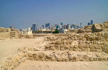 Stunning View of Bahrain Fort or Qal'at al-Bahrain Structure Ruins with Manama Modern Cityscape in the Backdrop, Bahrain