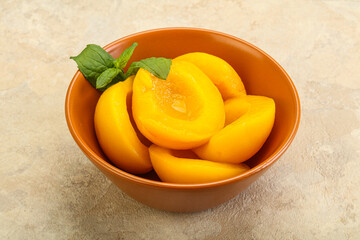 Sweet ripe canned peaches with mint