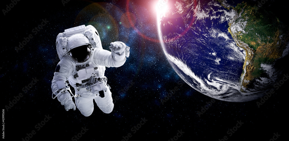 Wall mural astronaut spaceman do spacewalk while working for space station in outer space . astronaut wear full