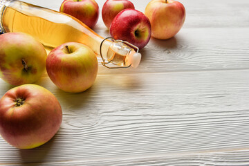 Apple juice bottle and apple wooden background with copy space.