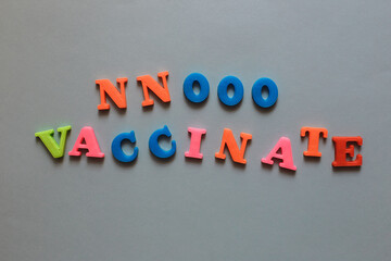 No Vaccinate. Anti-vaccination protest. The words are lined with letters from a plastic magnetic alphabet.