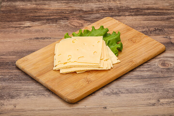 Sliced yellow cheese over board