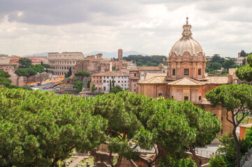 Fototapeta na wymiar Panoramic view of Colosseum, via Fori Imperiali and Santi Luca e Martina church, Rome, Italy
