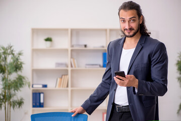 Young male employee working in the office