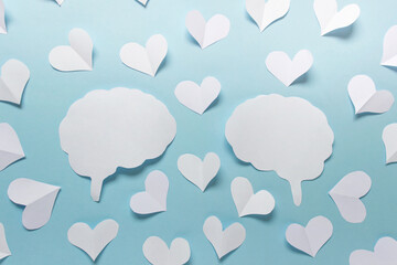 Fototapeta na wymiar Paper valentine love affection composition with two brain silhouettes and many white paper hearts on blue background