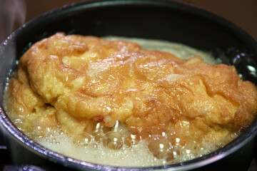 Crab omelette in heat oil for crispy on the outside ,soft on the inside omelette.