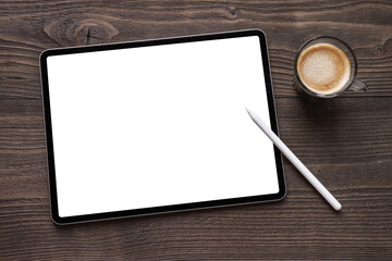 Tablet mockup with blank white screen and wireless stylus pen on dark wooden table