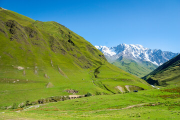 Fototapeta na wymiar idyllic alpine landscape with mountain for hiking and trekking with copy space, in countryside of Ushguli village with in Upper Svaneti region, Georgia.