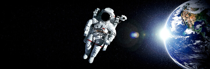 Astronaut spaceman do spacewalk while working for space station in outer space . Astronaut wear full spacesuit for space operation . Elements of this image furnished by NASA space astronaut photos. - Powered by Adobe