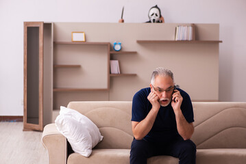 Fototapeta premium Devil visting old dying man at home