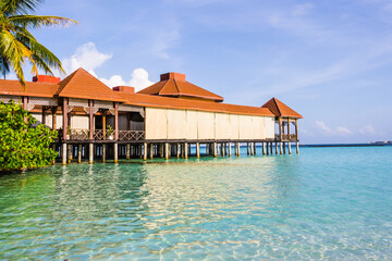 restaurant on stilts on the water in the Indian Ocean lagoon in the Maldives