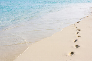 footprints on the white sands of the Maldives