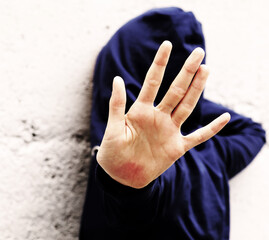 open hand of young girl trying to protect herself from violence
