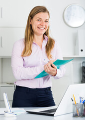 Young female manager ready to receive clients in her office