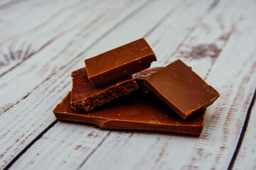 chocolate pieces on a white background, chocolate, sweet, food, dessert, brown, dark, isolated,...