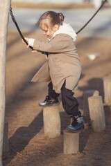 girl on the playground on a sunny spring day