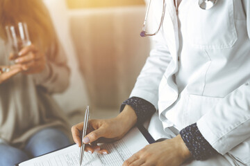 Close-up of woman-doctor and patient discussing current health examination while sitting indoors. Stay at home concept during Coronavirus pandemic and self isolation quarantine. Covid 2019