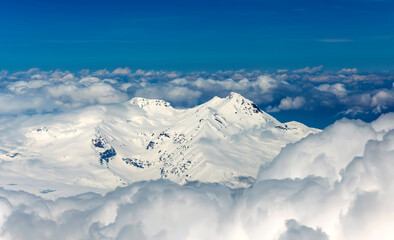 View through clouds at mountain peaks. Fantastic terrific natural landscape. Use for background,...