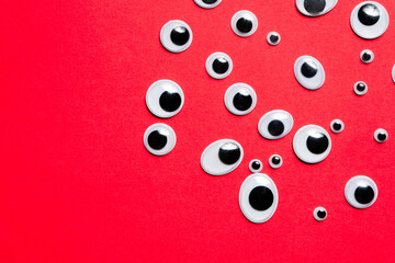 A bunch of toy eyes on an red background