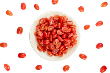 tomatoes cherry on plate on a table with white background as composition