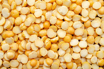 Dry organic split yellow mung bean background, read for clean food ingredient cooking or agricultural product concept