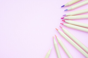 Top view of pastel pencil color on soft pink paper background