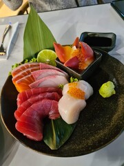 Fresh sashimi platter with kingfish, seared tuna, salmon and scallop at fine dining japanese restaraunt, beautiful plating 
